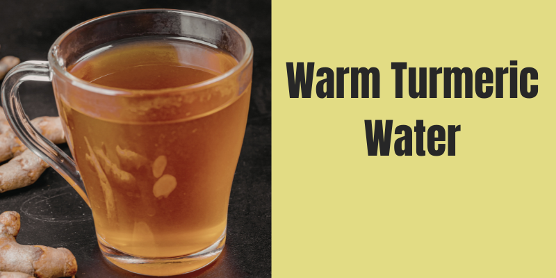 Glass of warm turmeric water showing a healthy morning drink made with turmeric and warm water.